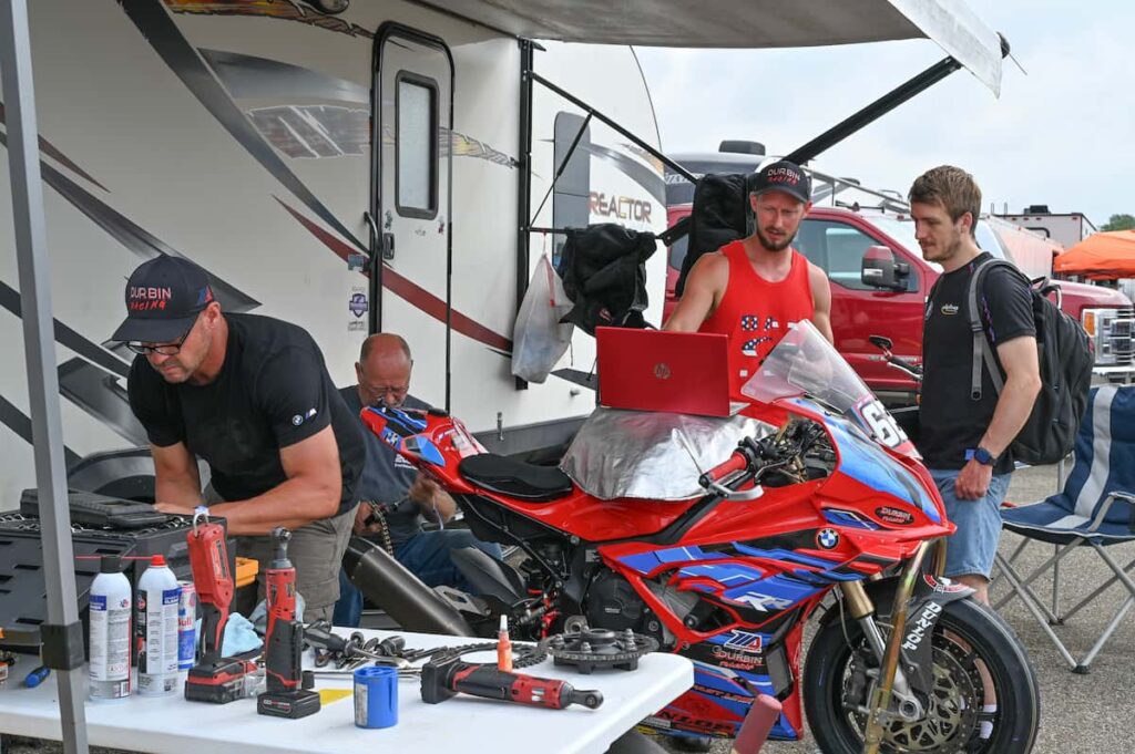 a group of men working on a motorcycle
