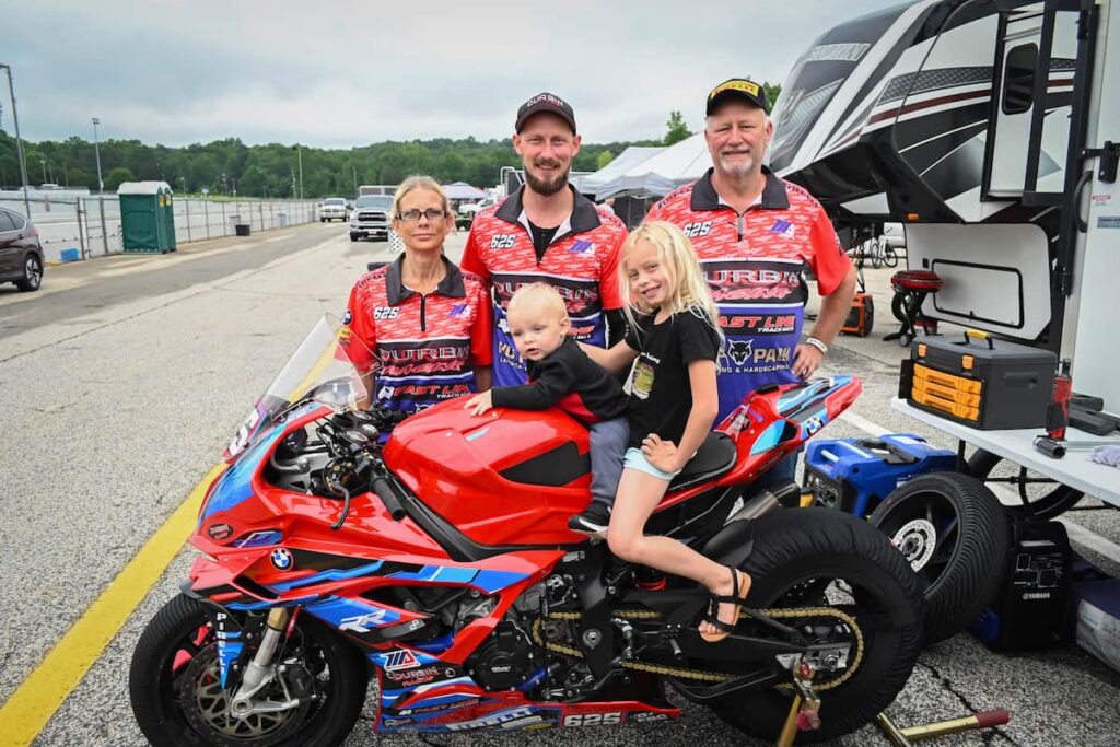a family around a race motorcycle
