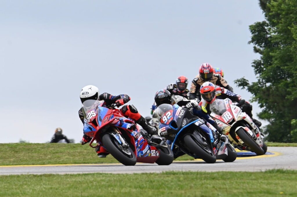 a group of motorcycle racers chasing each other.