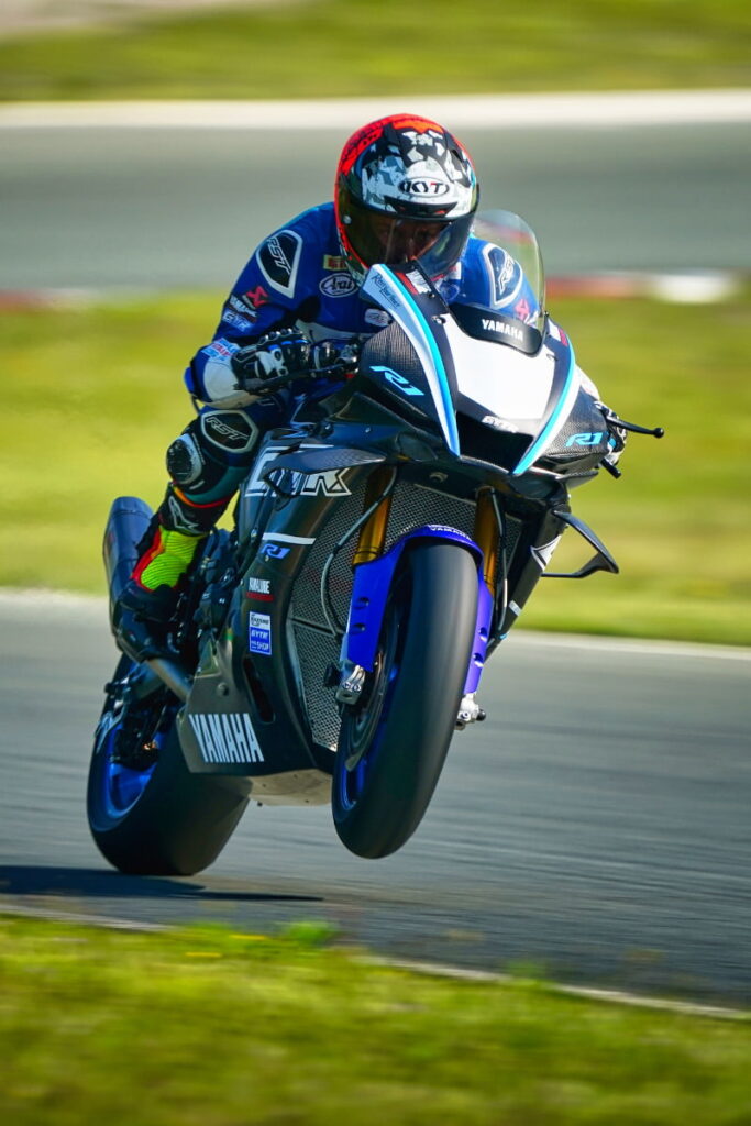 a motorcycle racer captured while wheelie