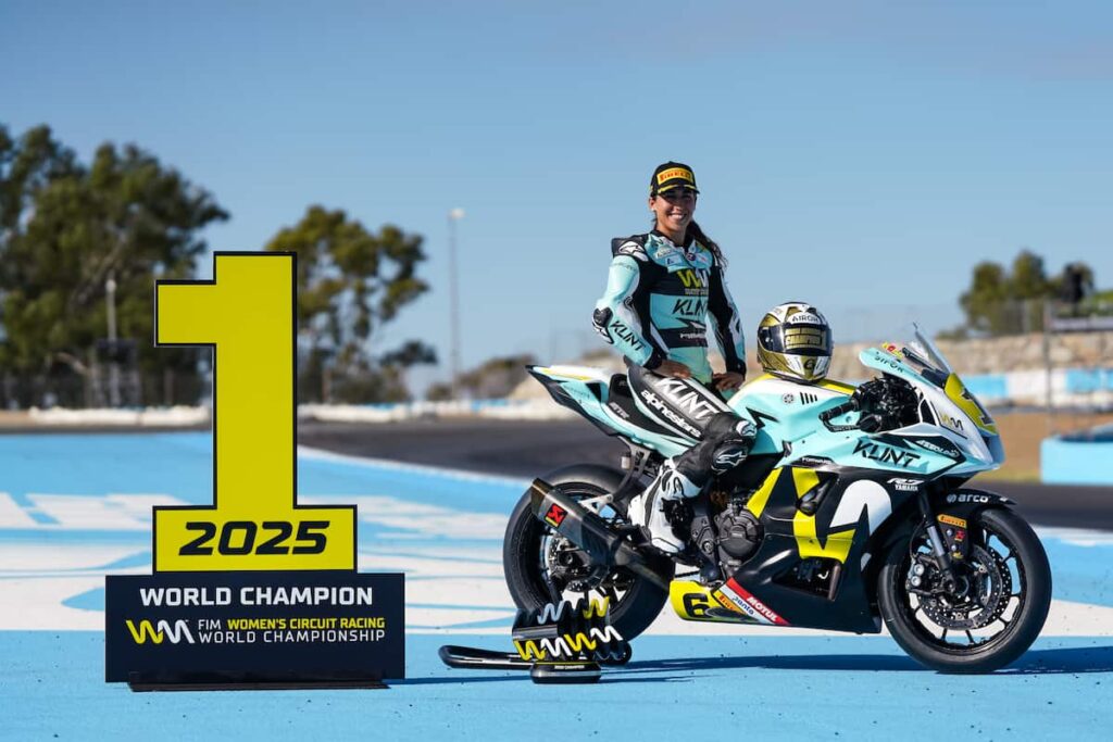 Women sitting on the bike with number one next to her world champion