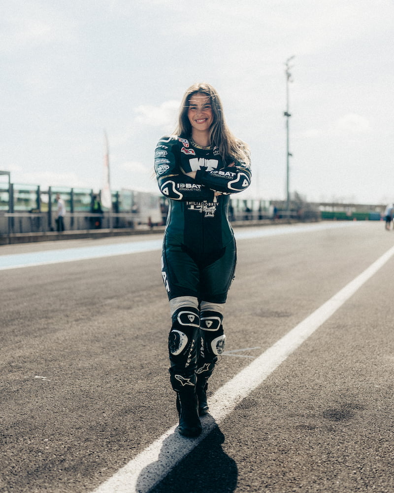 a woman in a motorcycle race suit