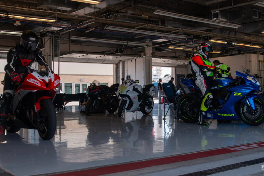 2 motorcycle riders getting out of paddock at COTA