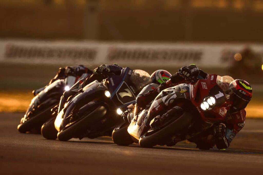 a group of motorcycle racers leaned
