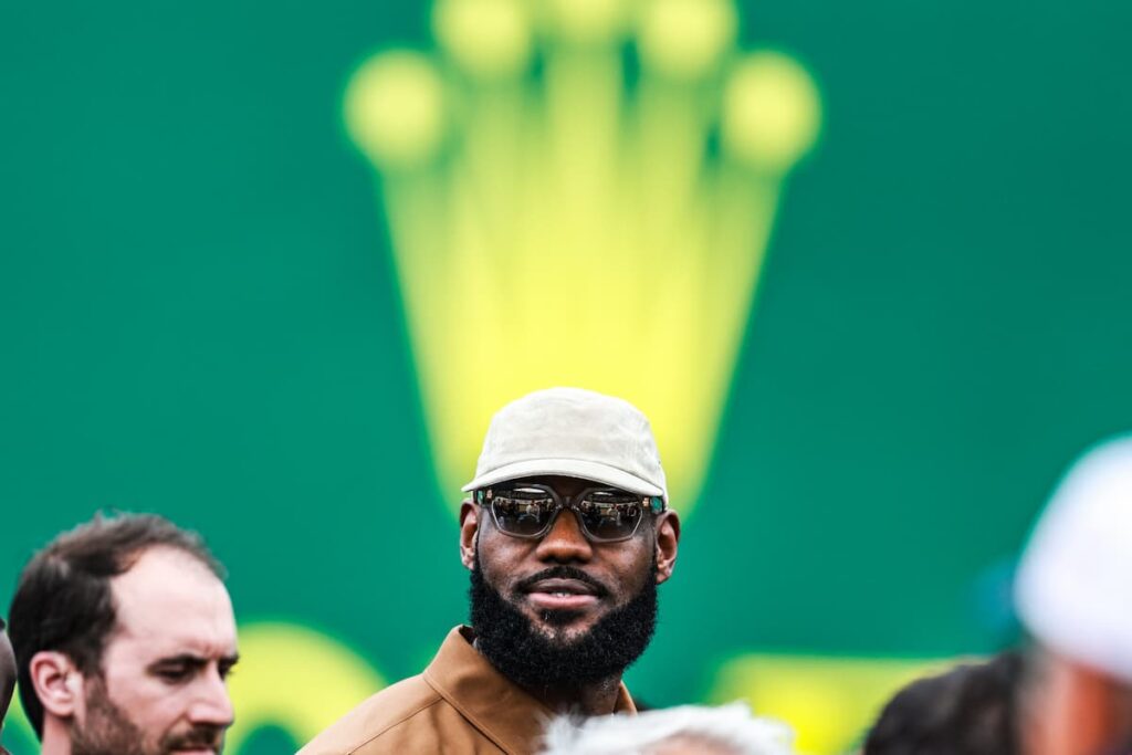 a man with a crown in the background on his head