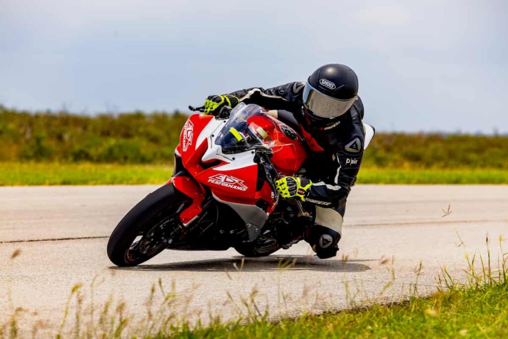 a motorcycle racer leaned at the apex
