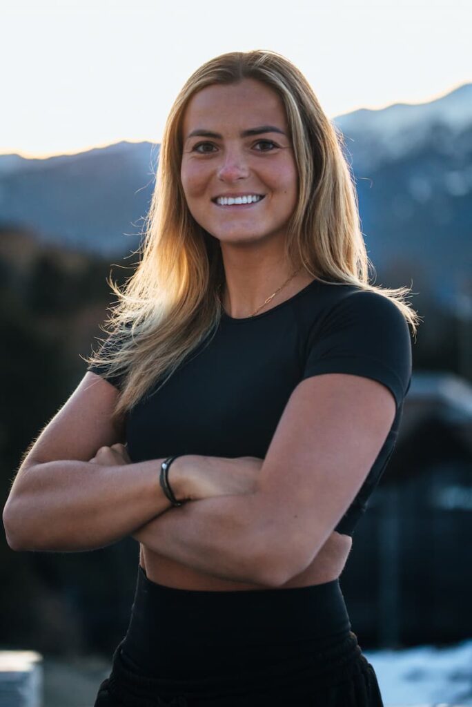 a woman smiling and looking at the camera