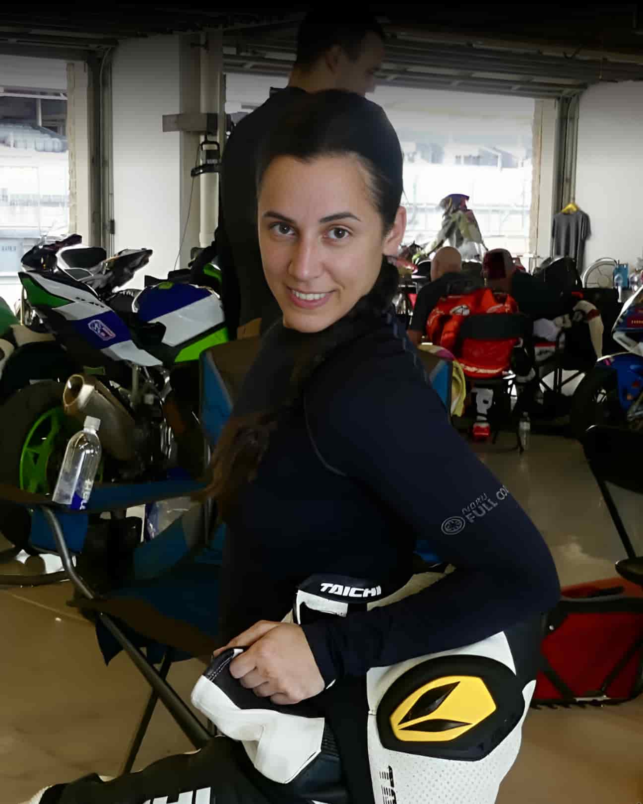 CREW a woman in her leather suit looking at the camera