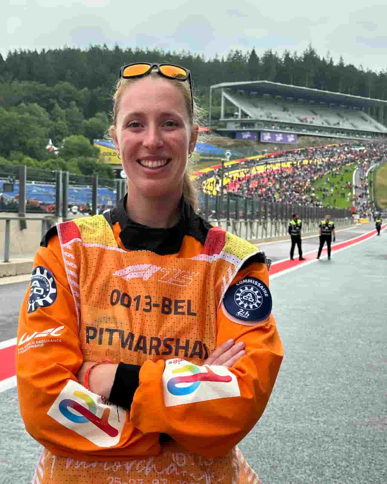 CREW A MotoGP marshal with the circuit behind her.