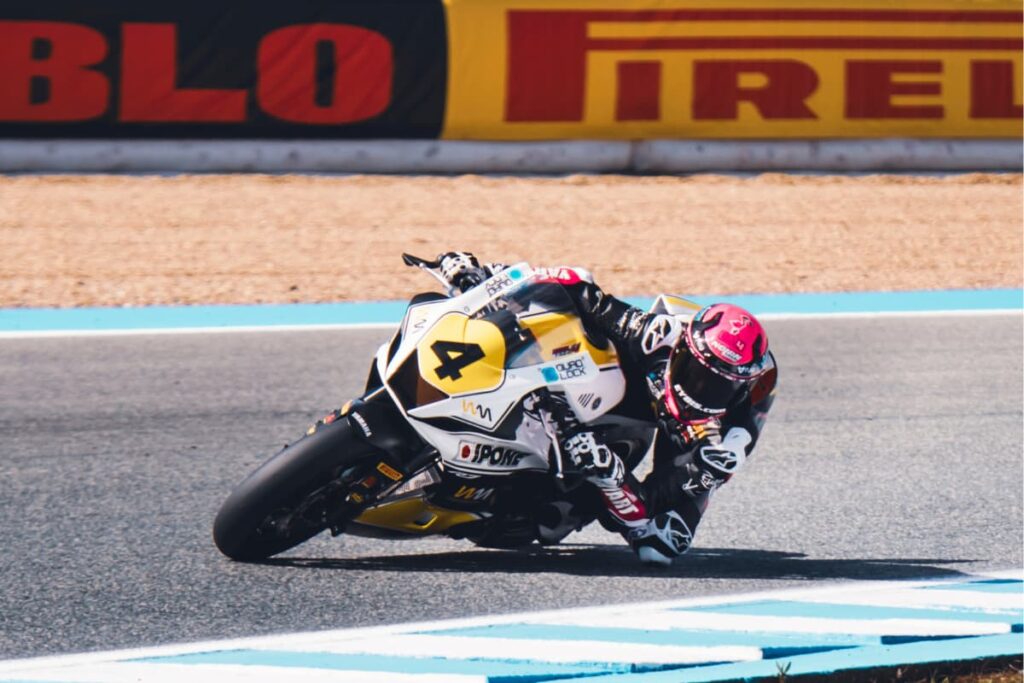 a motorcycle racer leaned at the apex