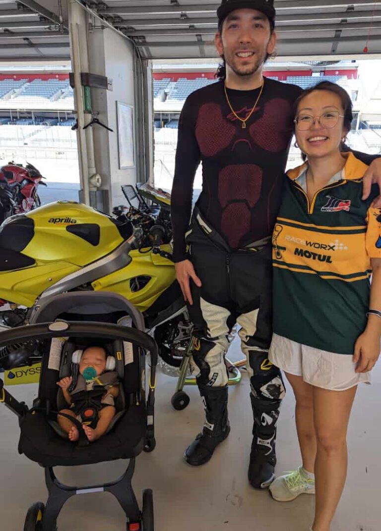 Motorcycle track racer with his family in the paddock