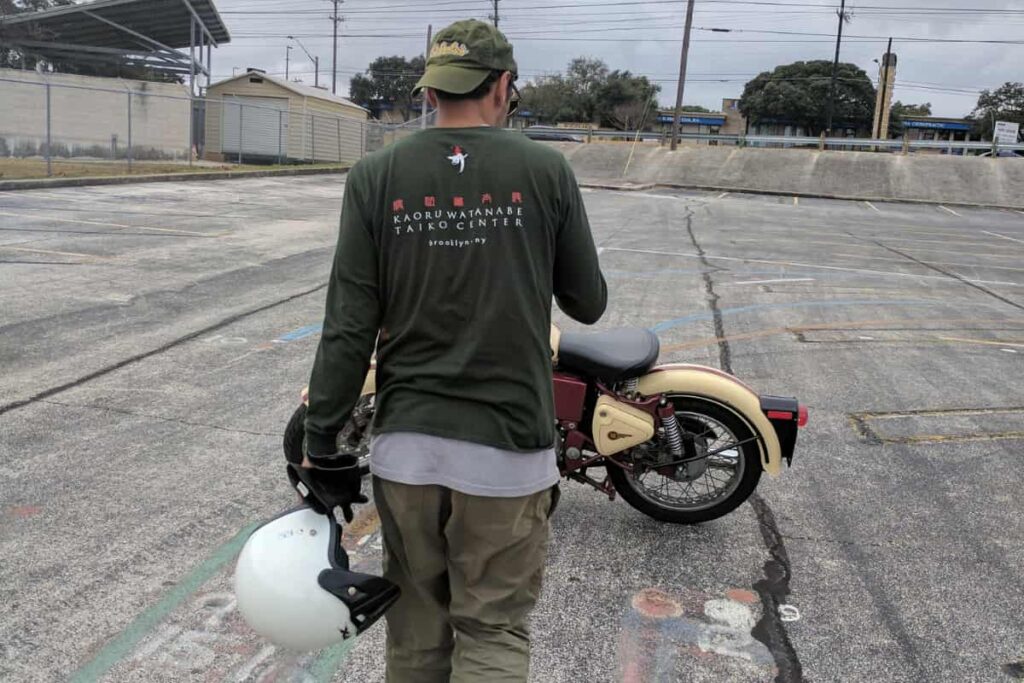 Sean Beenaam Sean Beenaam TrackDNA Rider walking towards his street motorcycle