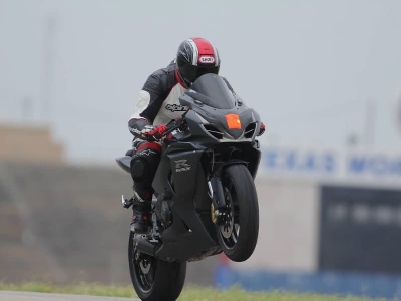 Motorcycle racer doing wheelie