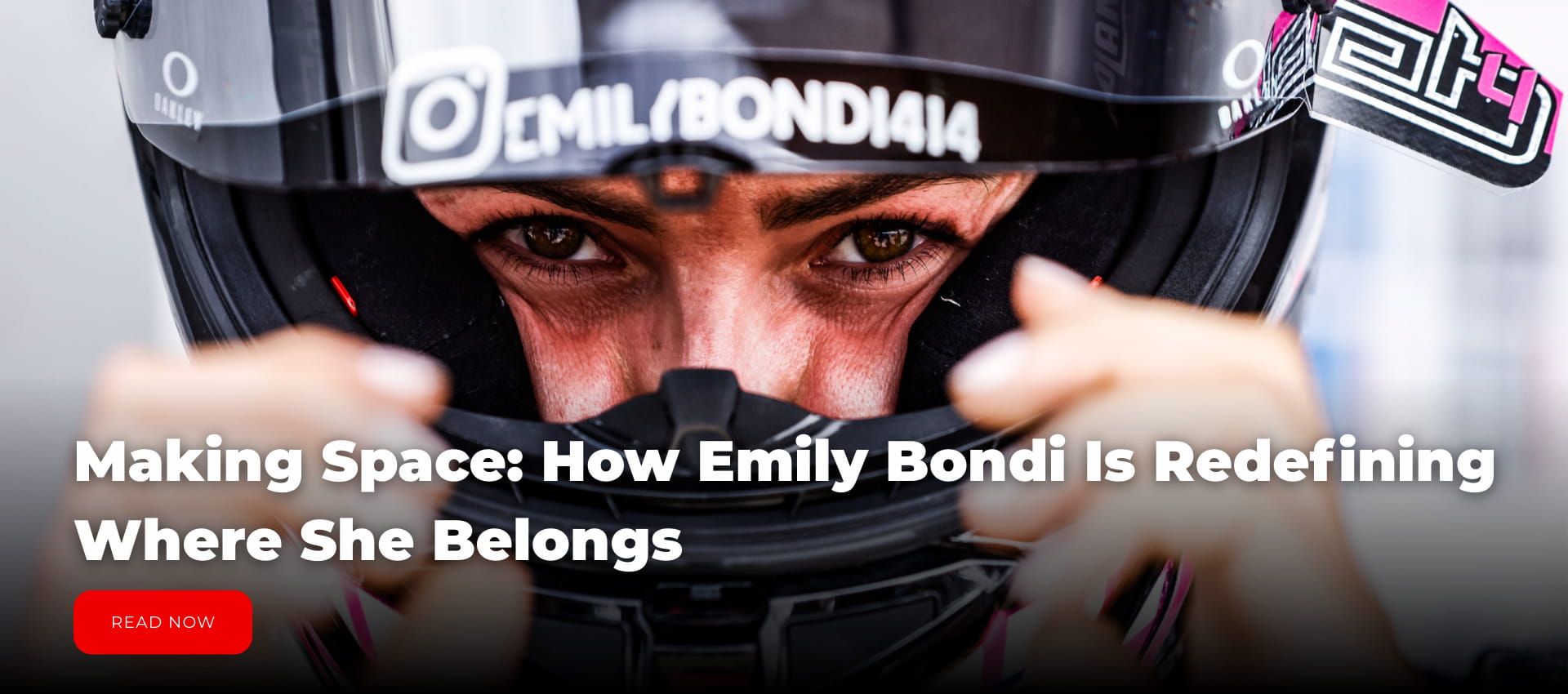 A woman in a motorcycle racing helmet