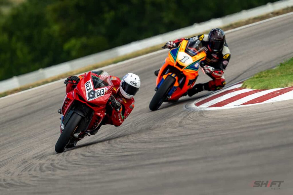 Aiden Sneed two motorcycle road racers leaned at the apex