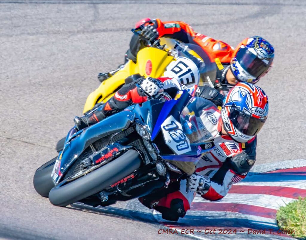 two motorcycle racers leaned at the apex