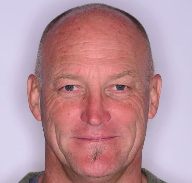 a man headshot smiling