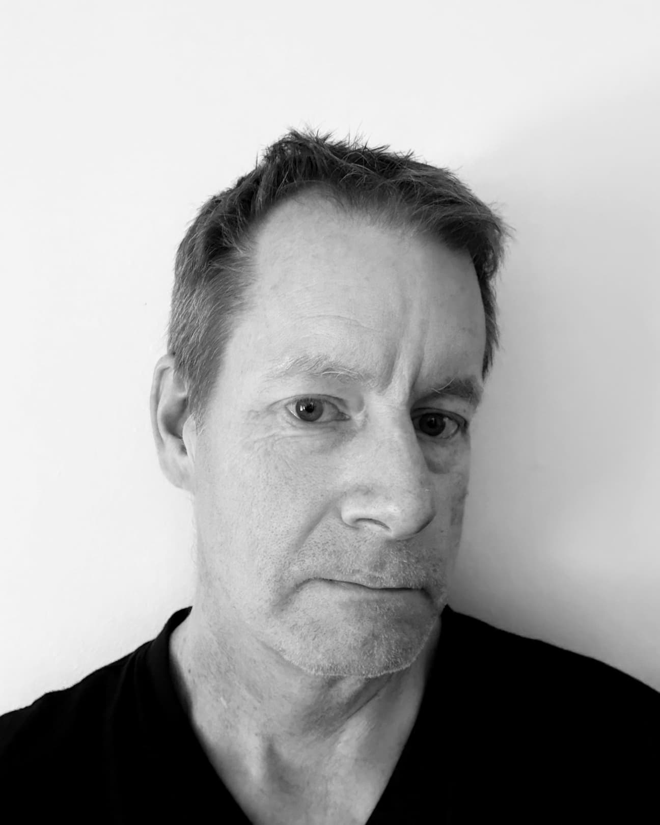 CREW A man in black-and-white photo looking at the camera