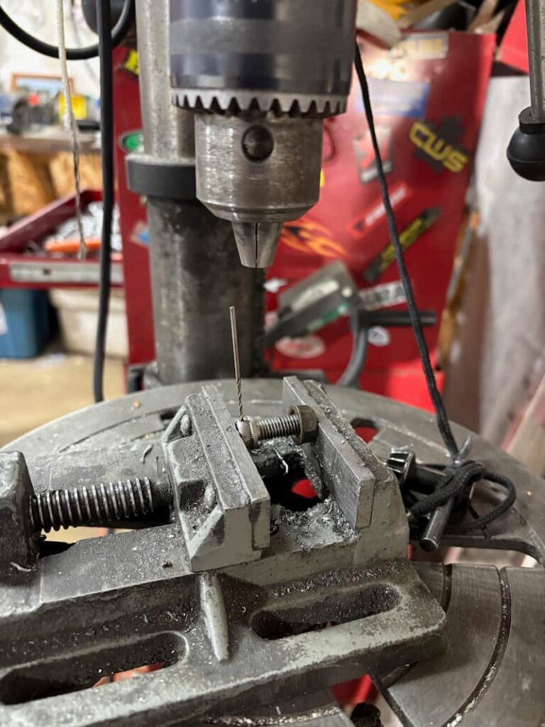 Brake caliper mounting bolt is being drilled out