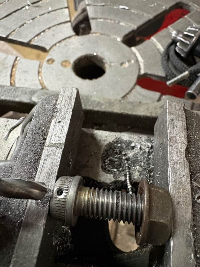 Motorcycle caliper mounting bolt is drilled