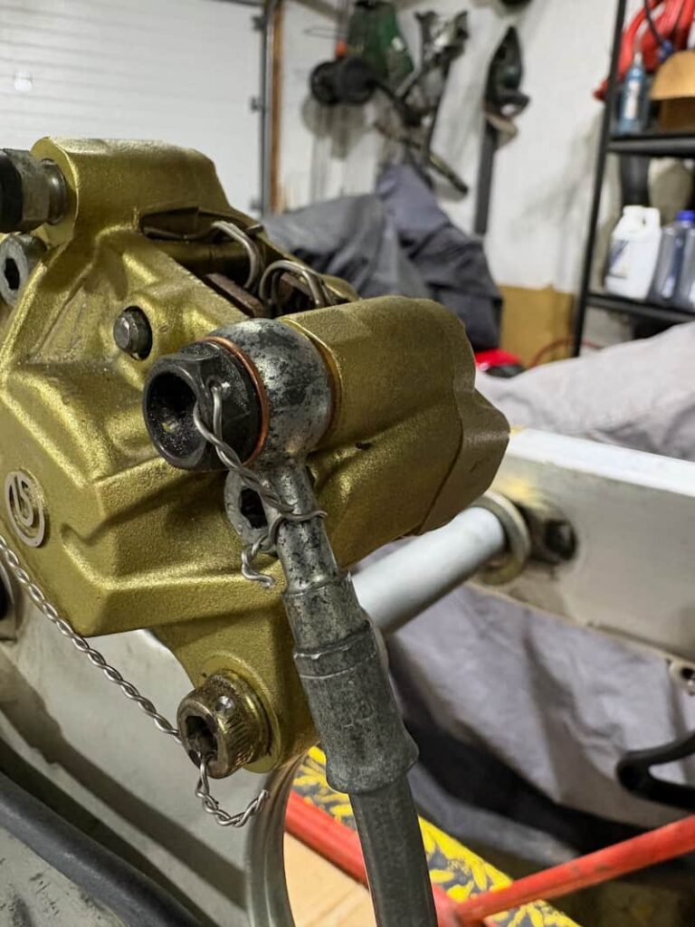 Safety wire around the brake caliper mountain bolts