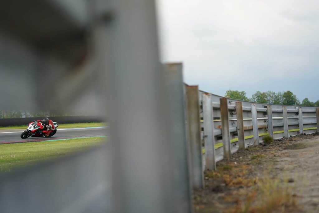 a shot behind the fence of a motorcycle racer on track