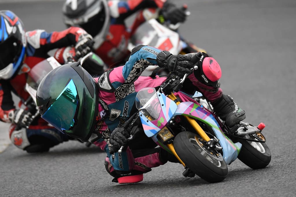a group of kid race mini motorcycles