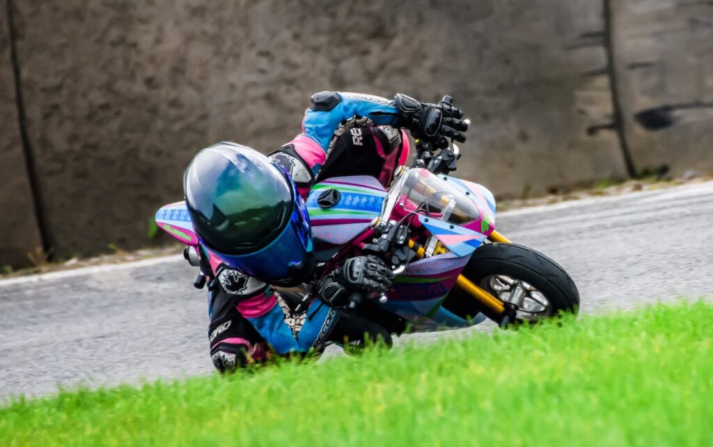 a kid on a mini race motorcycle leaned into the apex
