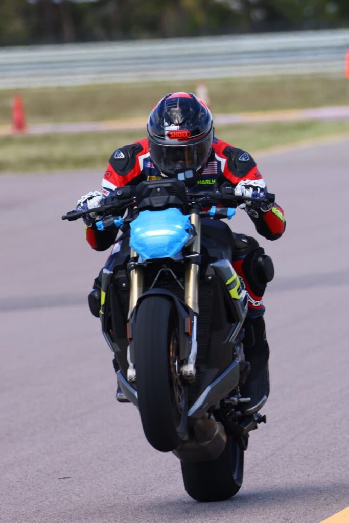 a motorcycle racer doing wheelie at the track