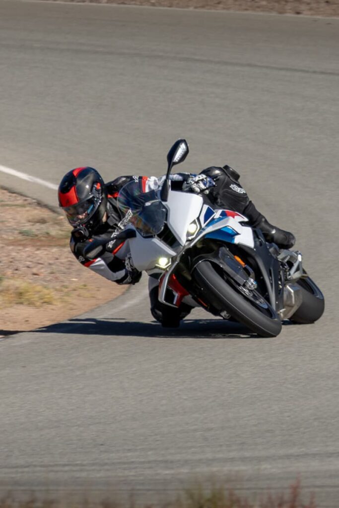 A motorcycle racer on a BMW S 1000 RR leaned at the Apex
