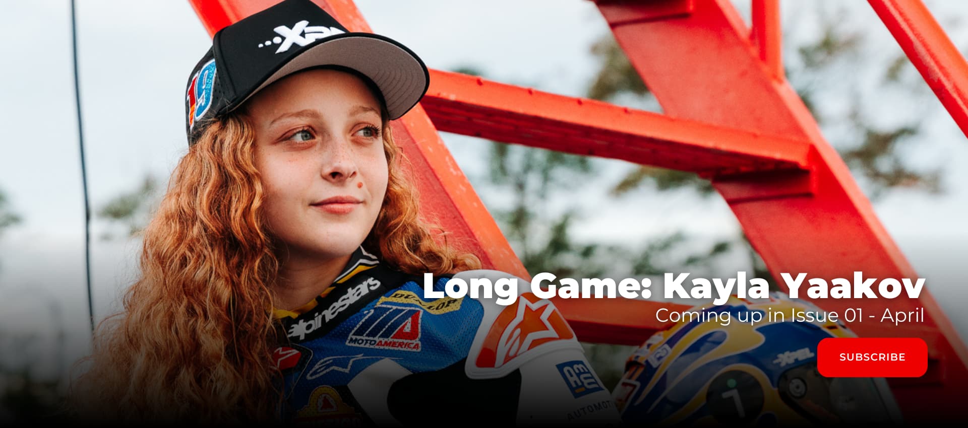 Kayla Yaakov an American road racer standing and looking at the track