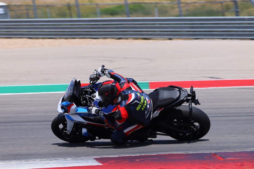 a motorcycle racer leaned at the apex