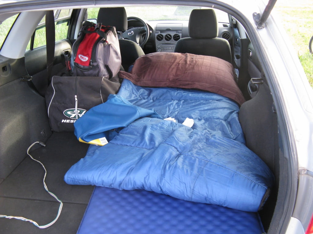 a van with a sleeping bag setup