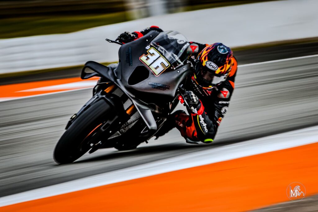 a motorcycle racer leaned into the apex