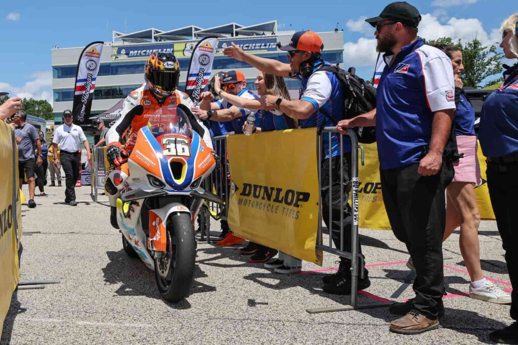 a motorcycle racer celebration at the end of the race