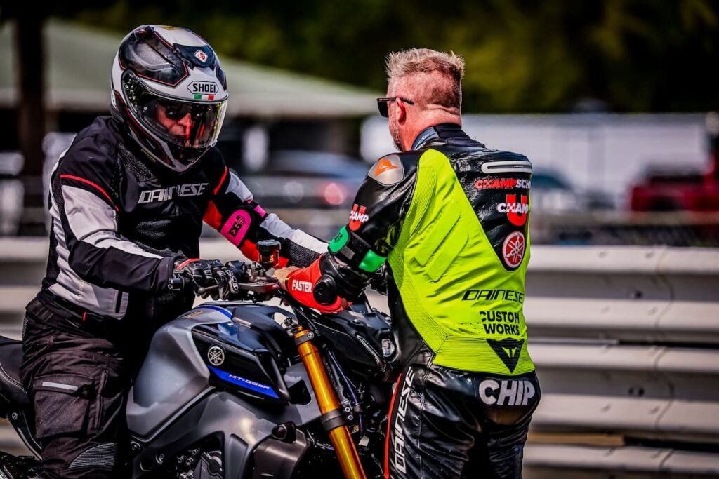 Motorcycle coach talking to a racer