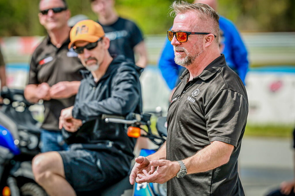 a coach talking to motorcycle track day riders