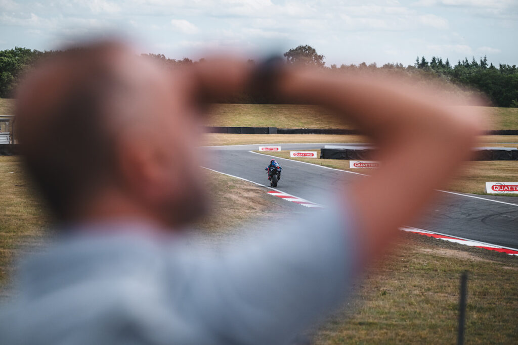 an inspector watching motorcycle racing