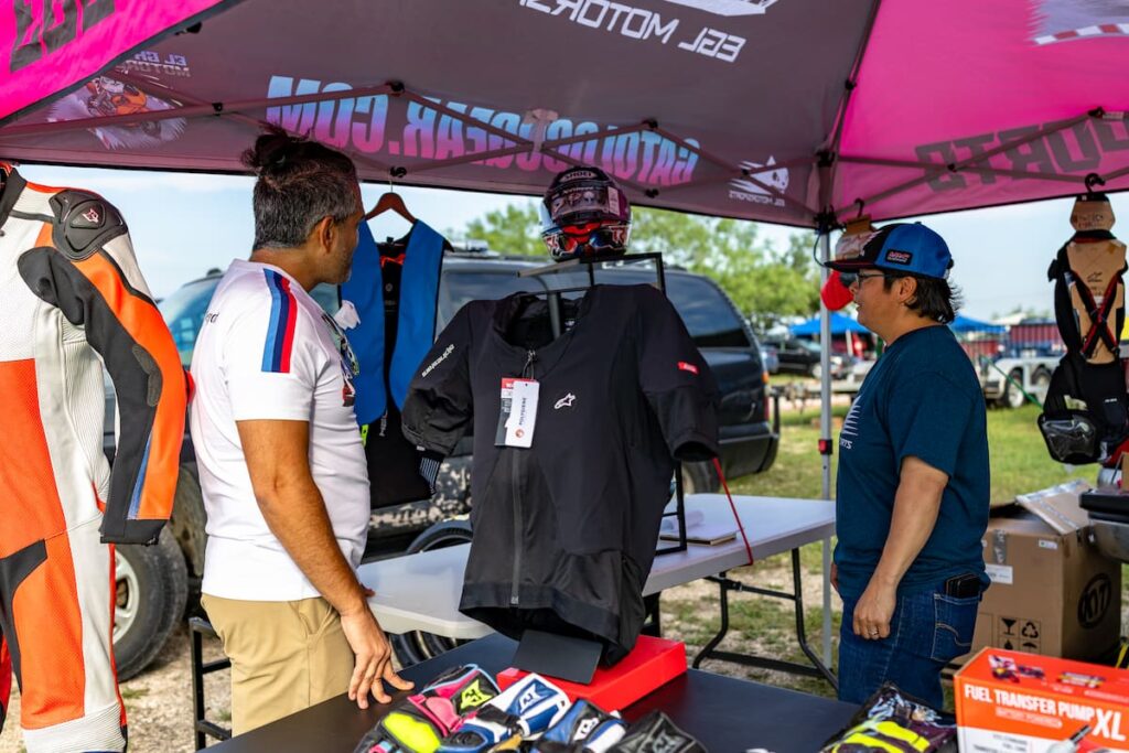 A vendor and a customer at the motorcycle race track